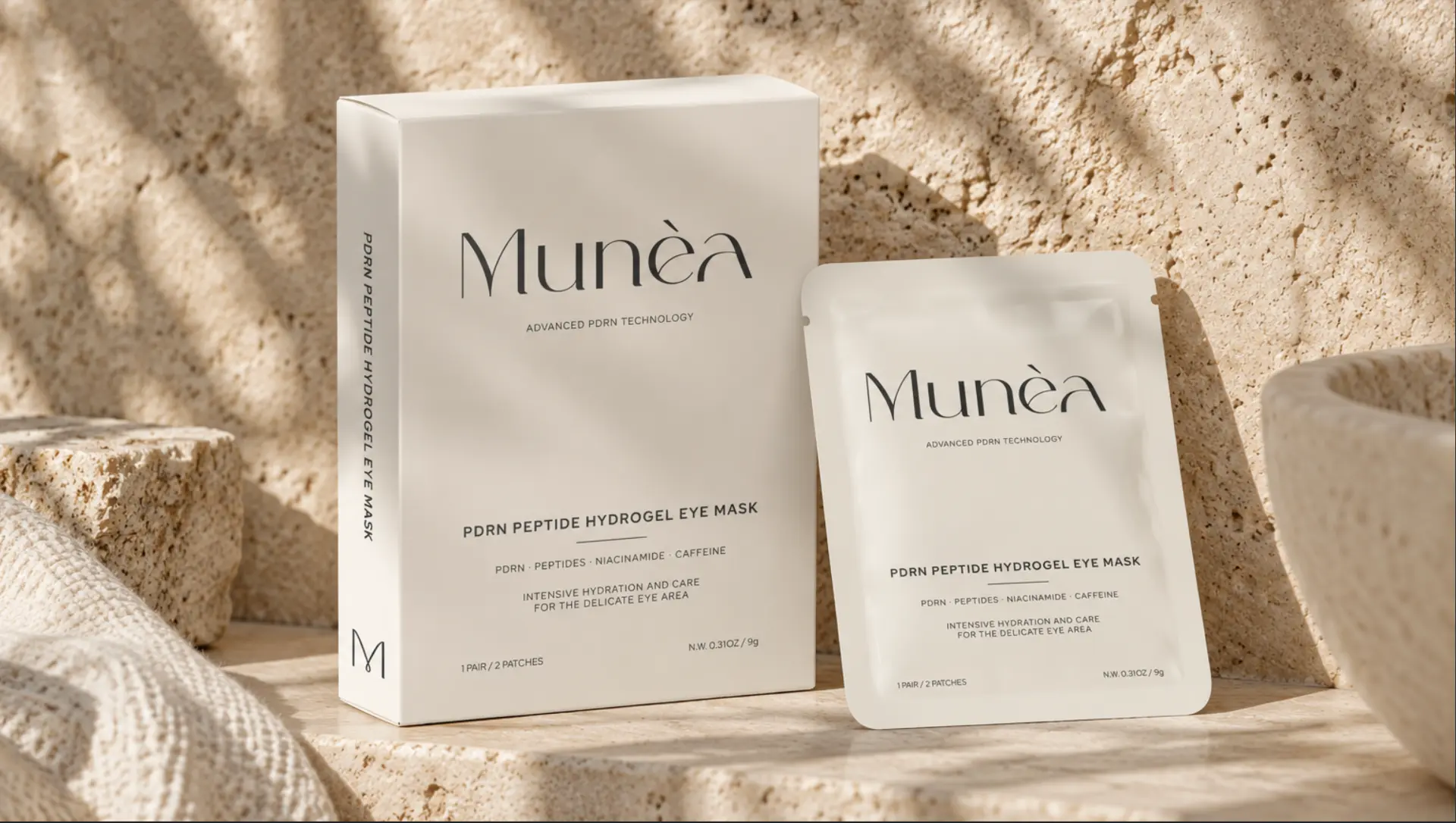 Munèa PDRN hydrogel eye mask box and sachet on warm limestone